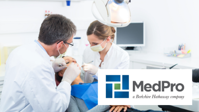 photo of a dentist, an assistant, and a dental patient in a treatment room chair